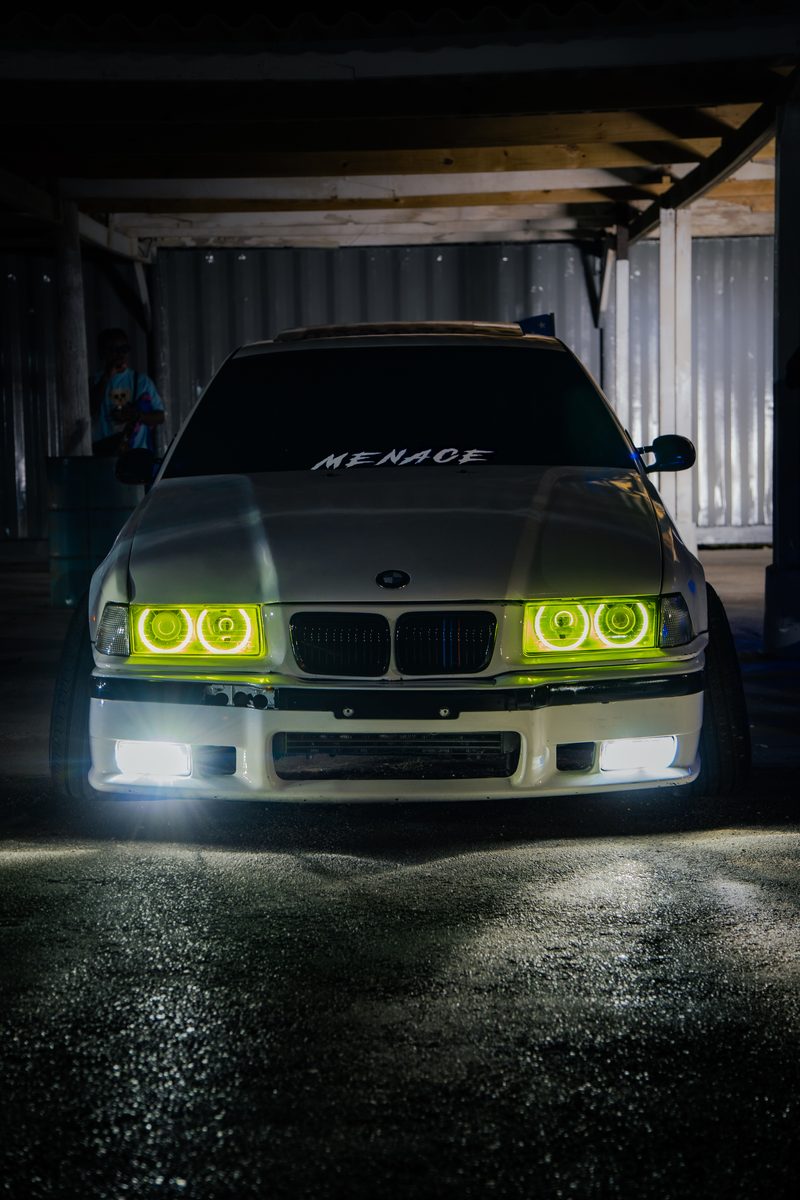 Modified BMW 3 Series with custom LED headlights at night