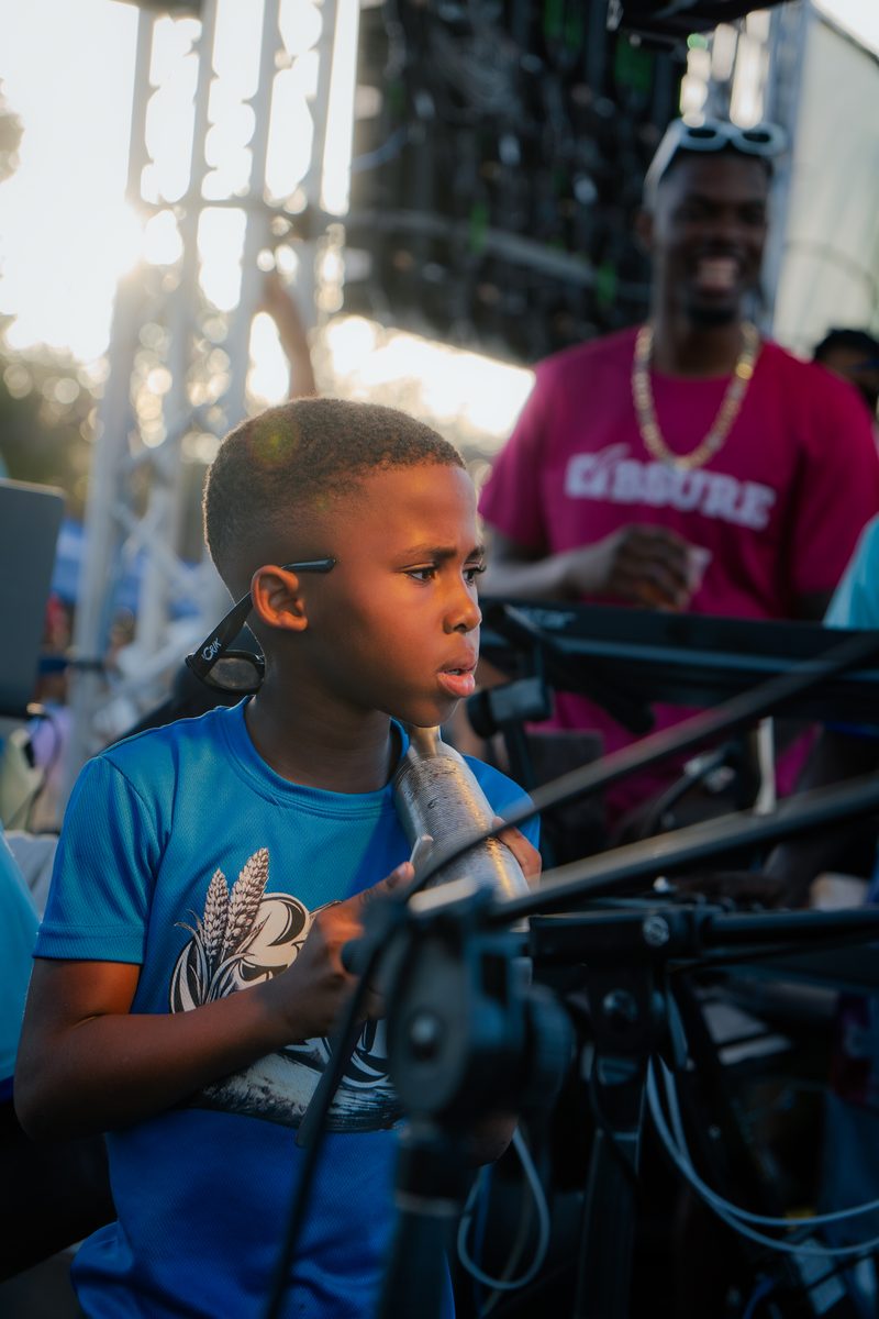 Young performer on stage at an outdoor event