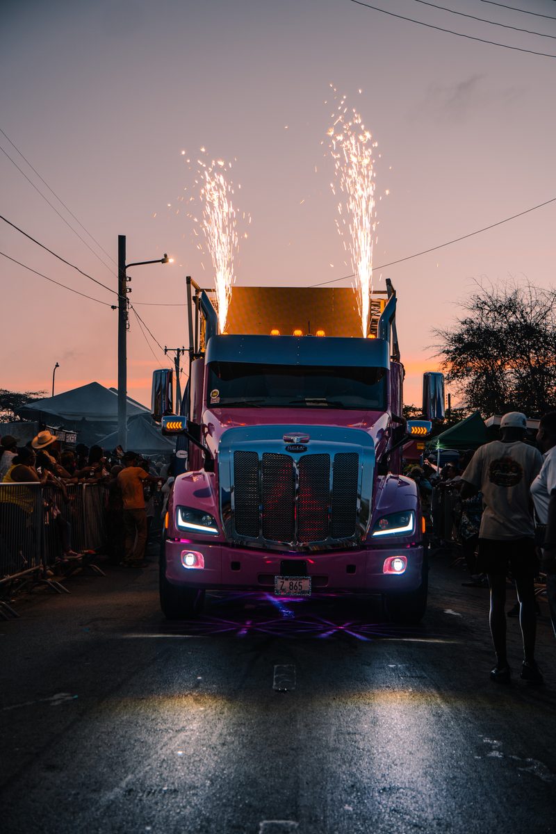 Decorated parade truck with pyrotechnics at dusk
